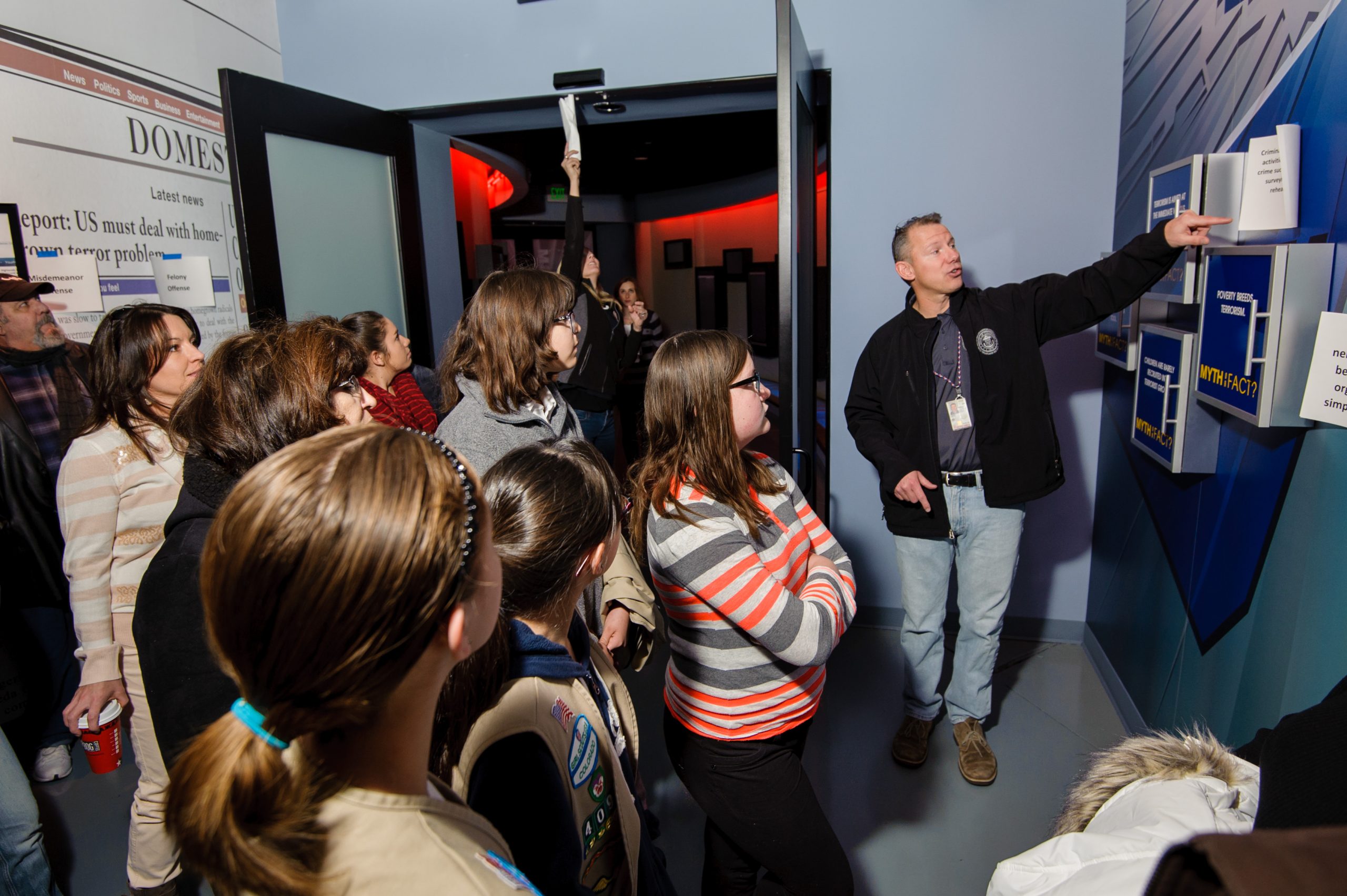 A group of people learning from a representative at the Counterterrorism Education Learning Lab (CELL) exhibit