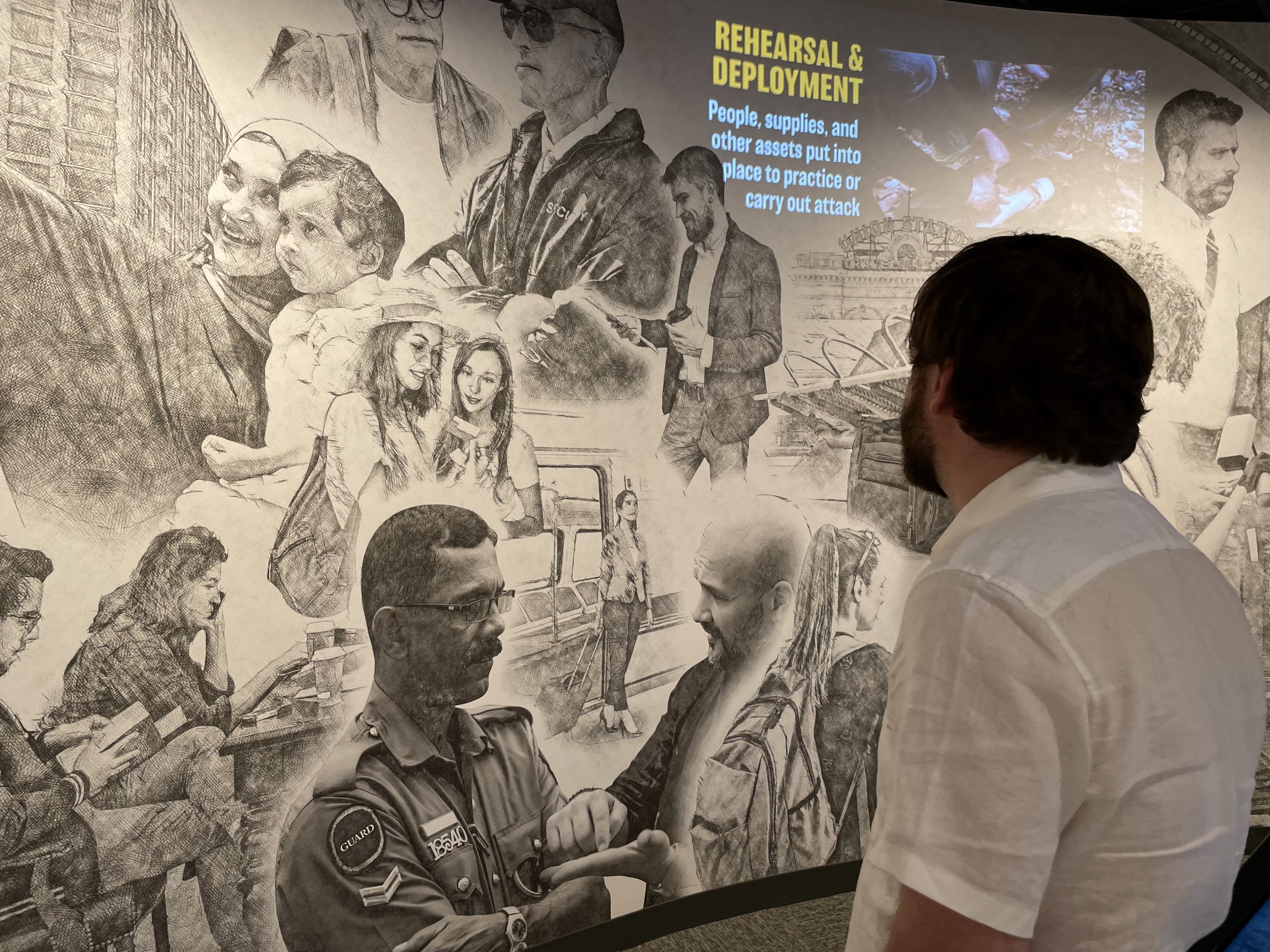 man viewing a portion of the Counterterrorism Education Learning Lab (CELL) exhibit