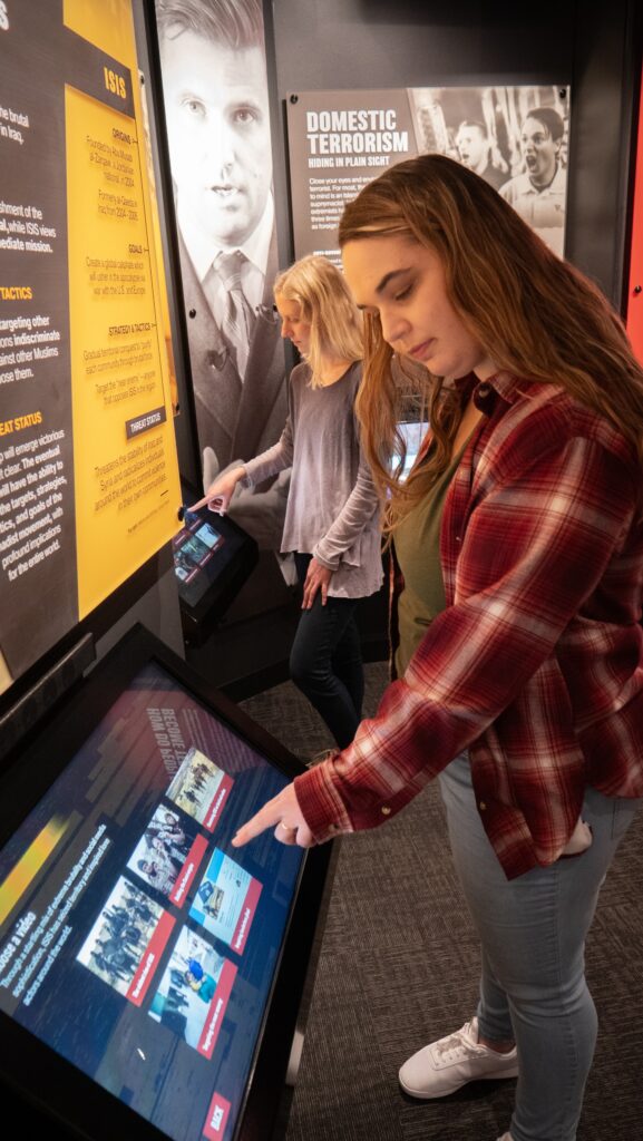 Two people looking at content at CELL Exhibit